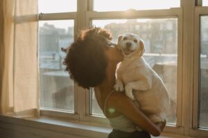 woman kissing cute dog